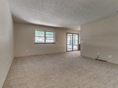 Carpeted empty room with a textured ceiling