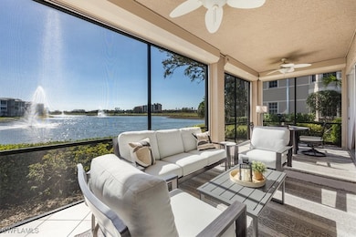 Sunroom featuring a water view, a textured ceiling, and tile patterned floors