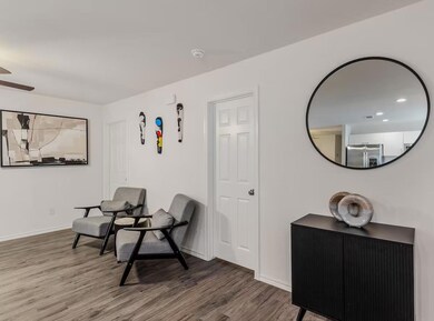 Living area with ceiling fan and hardwood / wood-s