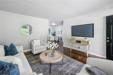 The living room offers a cozy, low-maintenance space ready for your furnishings and decor.