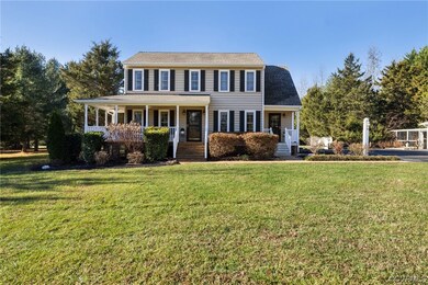 Colonial inspired home featuring a front yard and