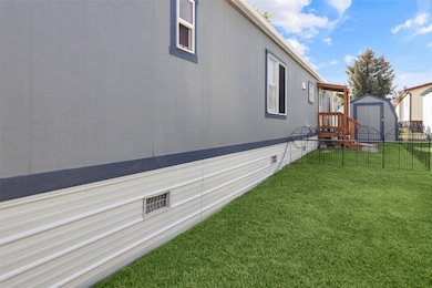 View of side of home featuring a storage unit