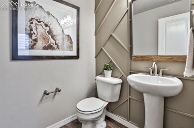 Bathroom with hardwood / wood-style flooring and t
