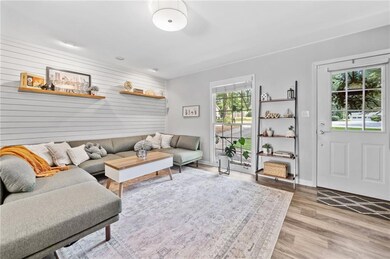 Living area with tons of natural light, wood-style floors, recessed lighting, and entrance mudroom.