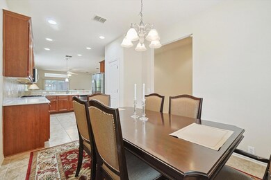 Tiled dining space with ceiling fan with notable c