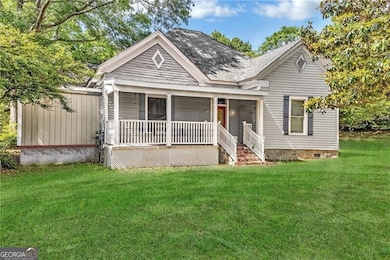 View of front of home with covered porch, crawl space, and a front yard