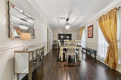 Large dining room with wood floors and neutral wal