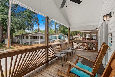 Wooden deck with ceiling fan and a residential vie