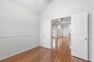 Unfurnished room featuring ceiling fan, wood finis