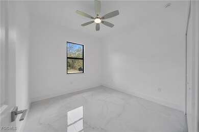 Unfurnished room with baseboards and ceiling fan