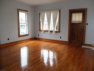 Lower unit's formal living room with refinished ha