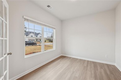 Spare room featuring wood finished floors and base