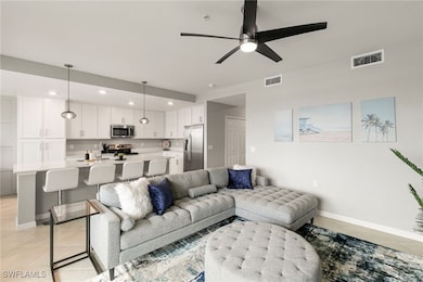 Living area with light tile patterned floors, recessed lighting, and ceiling fan