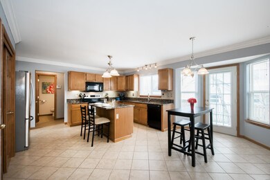 The spacious kitchen has a bay window with a door 