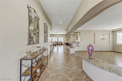 Hall featuring recessed lighting, a chandelier, an
