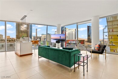 Living area with floor to ceiling windows, light tile patterned flooring, plenty of natural light, a chandelier, and a view of city