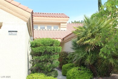 View of side of home with stucco siding and a tile