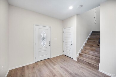 Entrance foyer featuring wood finished floors, recessed lighting, baseboards, and stairway
