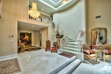Enter beautiful foyer, marble floors chandelier an