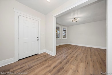 Foyer featuring wood finished floors and a textured ceiling