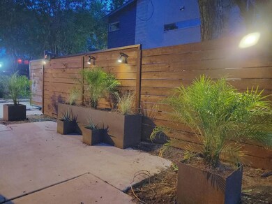 View of patio featuring fence