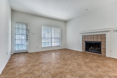 Unfurnished living room with a fireplace and baseboards