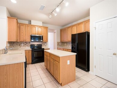 Kitchen with double sink, tile floors and center i