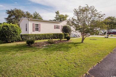 View of side of home with a yard