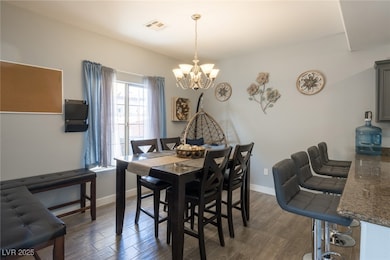 Dining area with a chandelier, dark wood finished