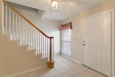 Foyer opens to stairway and formal living room (no