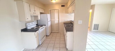 Kitchen featuring white appliances, under cabinet