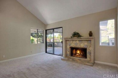 The living room features volume ceilings, an invit