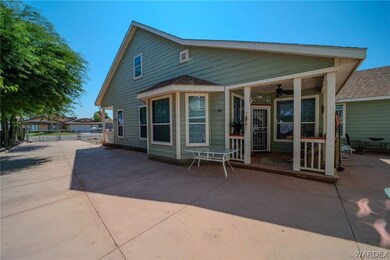 Back of property with ceiling fan and a patio area
