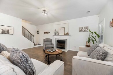 Great room fireplace and stairway to upper level