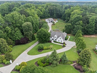 View from above of property featuring a heavily wooded area