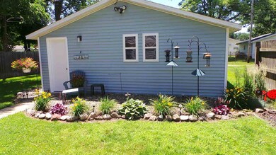 The detached garage is even well landscaped around