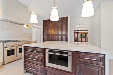 Kitchen featuring decorative light fixtures, stain