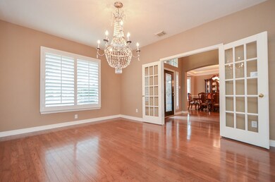 Private study off the foyer with French doors, hardwood floors and plantation shutters