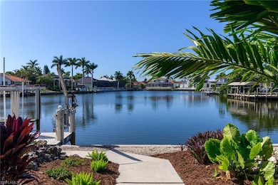 Water view featuring nearby suburban area, a dock, and boat lift