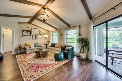 Family room with exposed beams and custom chandelier