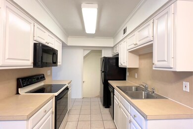 Kitchen featuring sink, light tile patterned floor