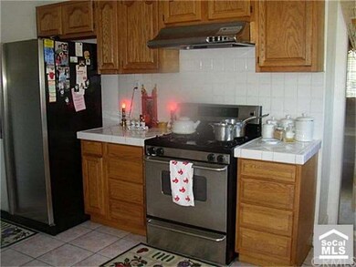 Kitchen with bright white tile counters