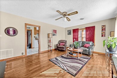 Living room with original hardwood and wood trim t