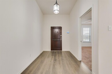 Entryway featuring ceiling fan and light hardwood / wood-style flooring