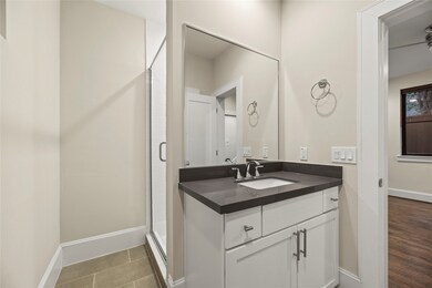 The secondary bathroom includes a walk-in shower a
