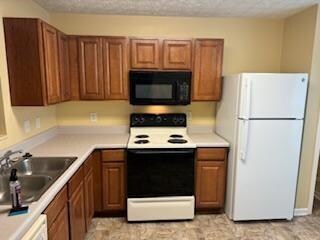Kitchen featuring sink and white appliances