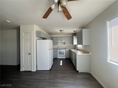 Kitchen with white appliances, a sink, a ceiling f