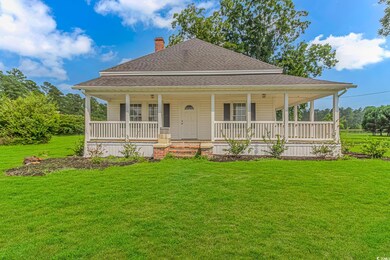 Farmhouse-style home featuring covered porch and a