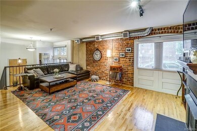 Living room is spacious with hardwood floor, expos