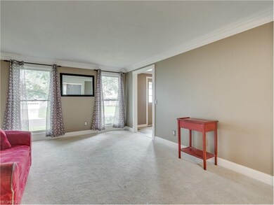The living room is also open to the foyer and feat